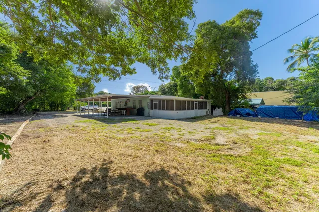 a swimming pool with outdoor seating and yard