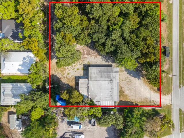 an aerial view of a house with a yard and garden