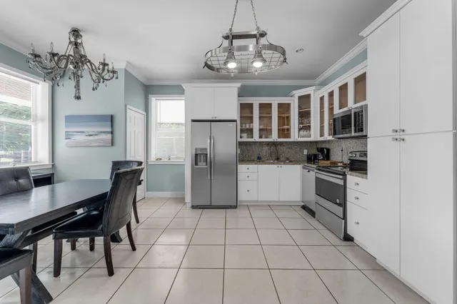 a kitchen with stainless steel appliances granite countertop a refrigerator and a stove top oven