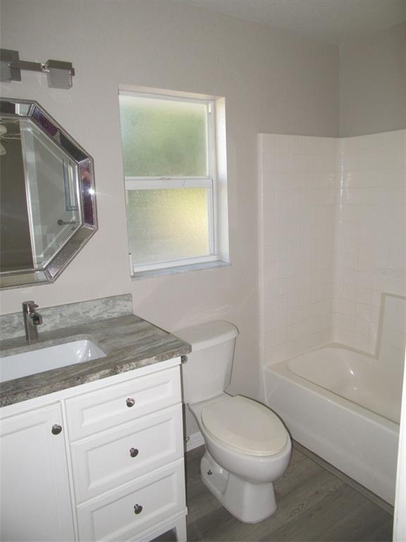 1090 Nomad Road Punta Gorda, FL 33983 - Photo 13 of 16 a bathroom with a granite countertop toilet sink and mirror