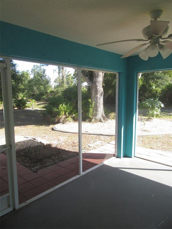 1090 Nomad Road Punta Gorda, FL 33983 - Photo 15 of 16 a view of a glass door with a yard from a balcony