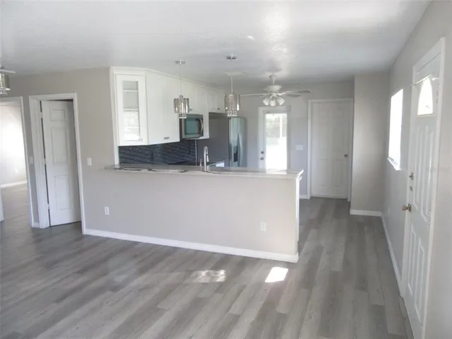 a view of a kitchen cabinets and wooden floor
