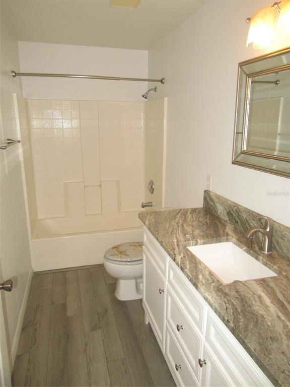 1090 Nomad Road Punta Gorda, FL 33983 - Photo 8 of 16 a bathroom with a granite countertop sink toilet and shower