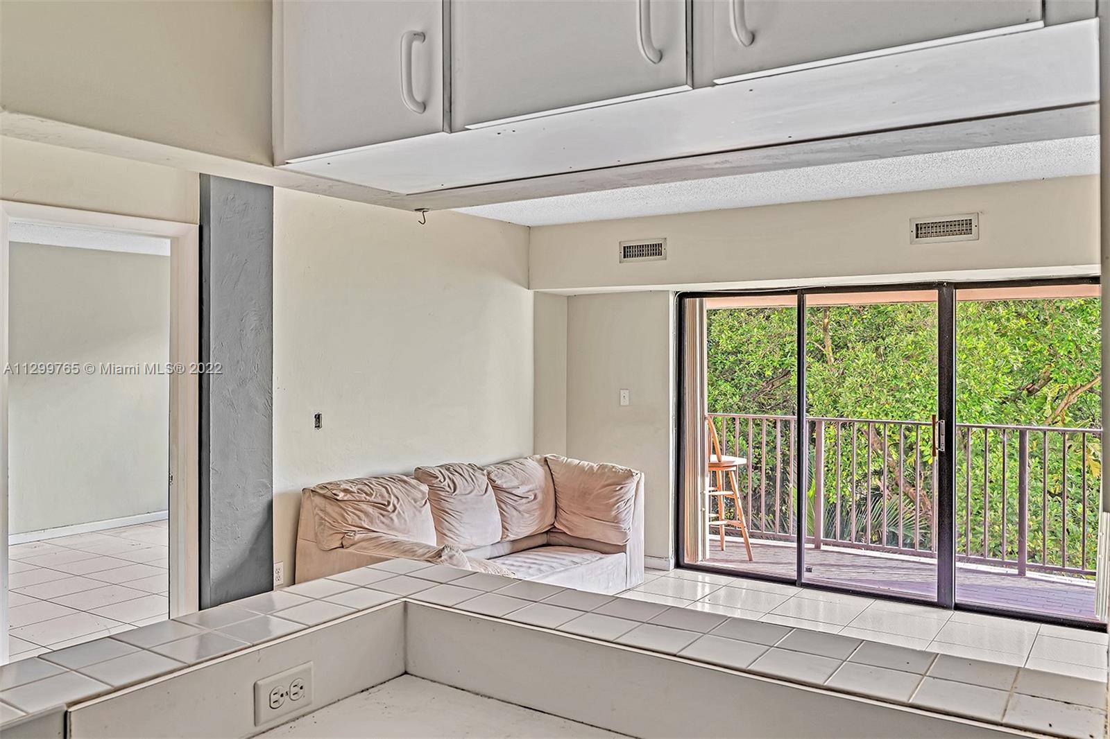 2201 Brickell Avenue, Unit 89 Miami, FL 33129 - Photo 13 of 56 a living room with furniture and a floor to ceiling window