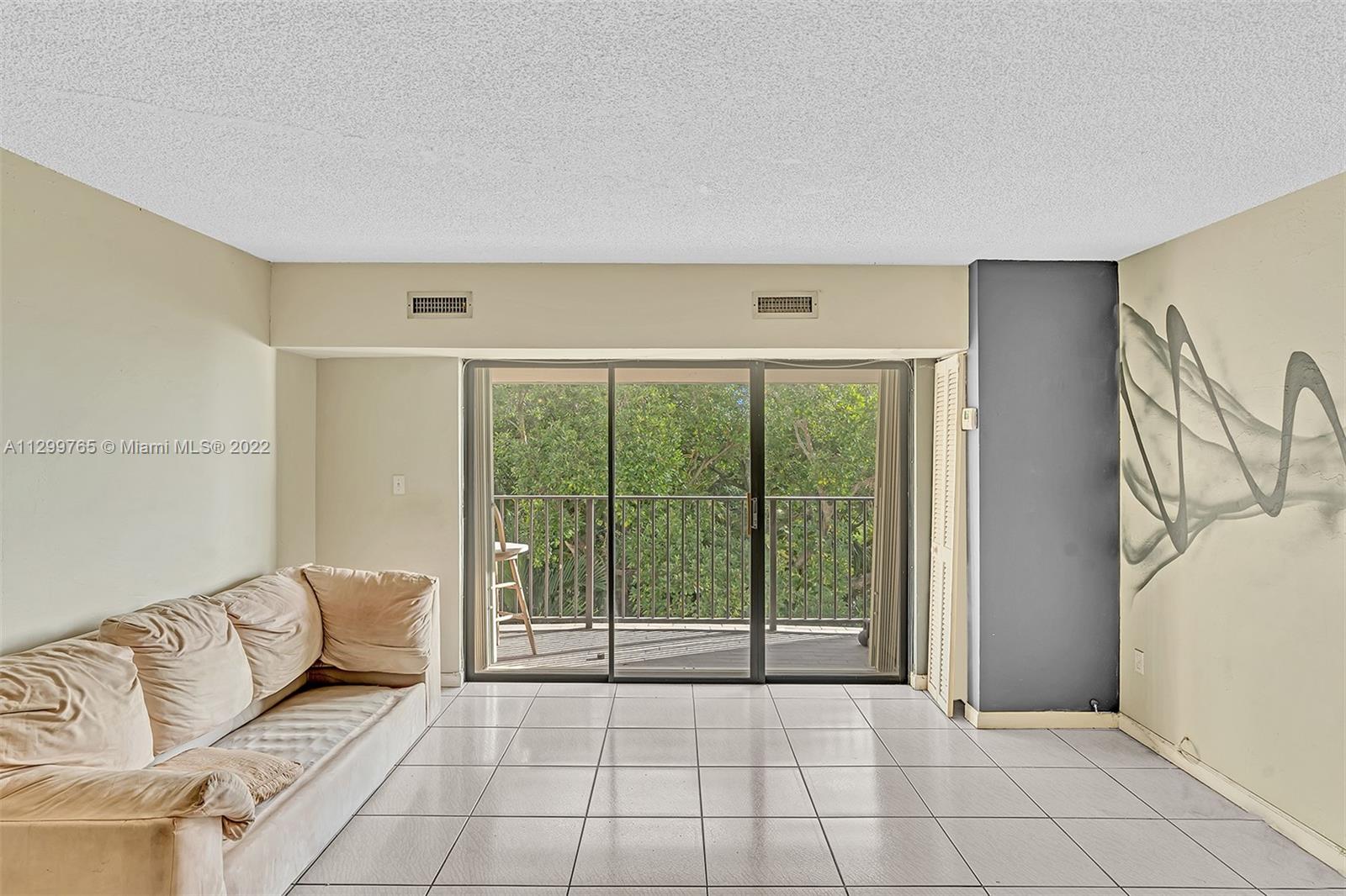 2201 Brickell Avenue, Unit 89 Miami, FL 33129 - Photo 15 of 56 a living room with furniture and a flat screen tv