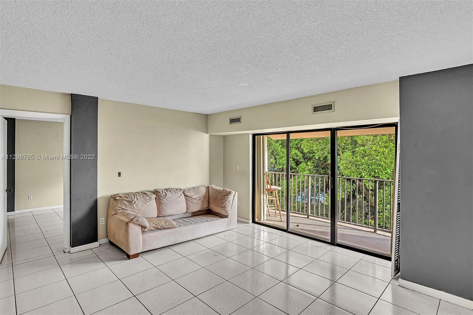 2201 Brickell Avenue, Unit 89 Miami, FL 33129 - Photo 17 of 56 a living room with furniture and a floor to ceiling window