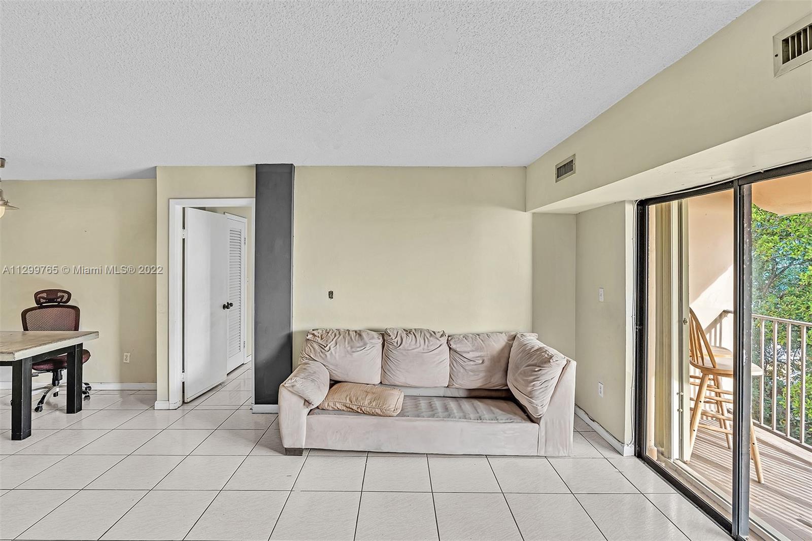 2201 Brickell Avenue, Unit 89 Miami, FL 33129 - Photo 18 of 56 a living room with furniture and a large window