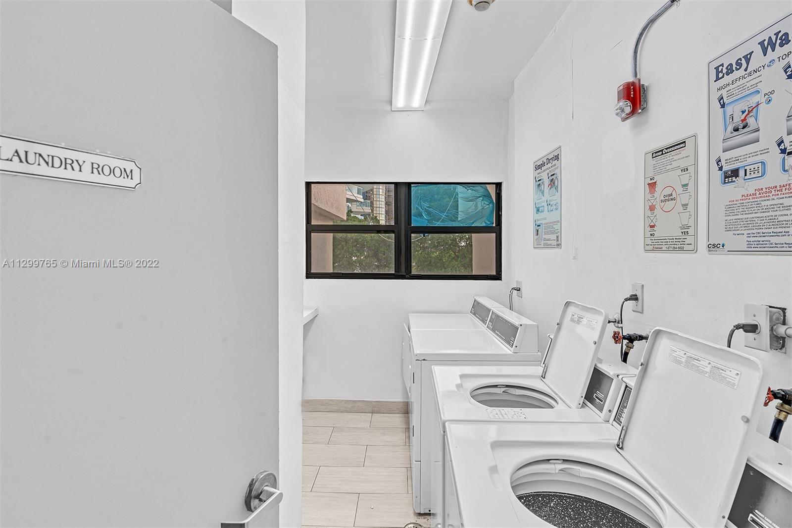 2201 Brickell Avenue, Unit 89 Miami, FL 33129 - Photo 33 of 56 a bathroom with a sink and a washer dryer