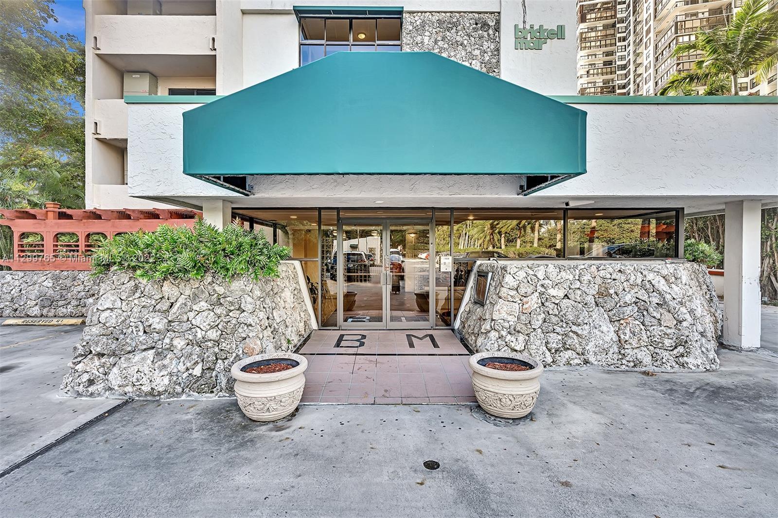 2201 Brickell Avenue, Unit 89 Miami, FL 33129 - Photo 4 of 56 a front view of a house with garden and outdoor seating