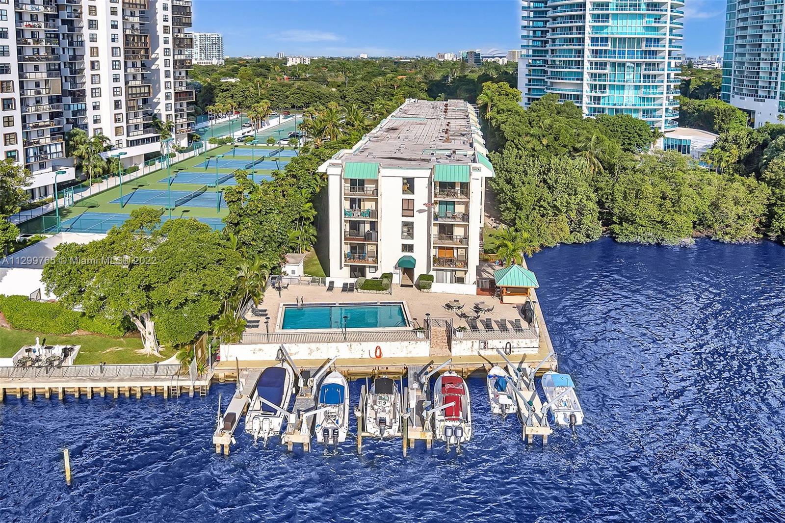 2201 Brickell Avenue, Unit 89 Miami, FL 33129 - Photo 45 of 56 a view of a patio with table and chairs and potted plants