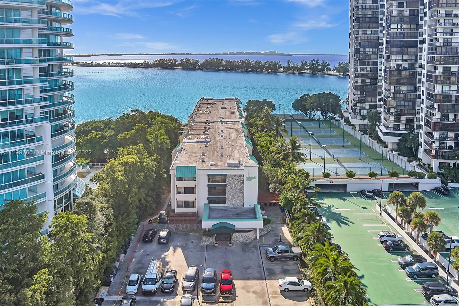 2201 Brickell Avenue, Unit 89 Miami, FL 33129 - Photo 53 of 56 a aerial view of a house with a lake and a building in the background