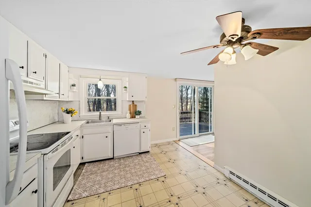 a kitchen with a sink cabinets and window