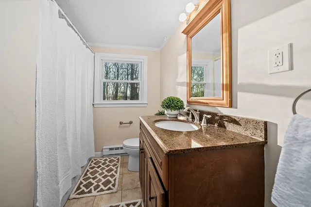 a bathroom with a granite countertop sink a mirror and a window