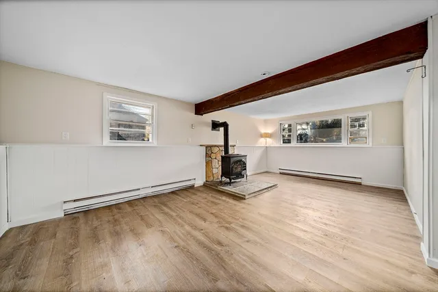 a view of a livingroom with wooden floor and a window