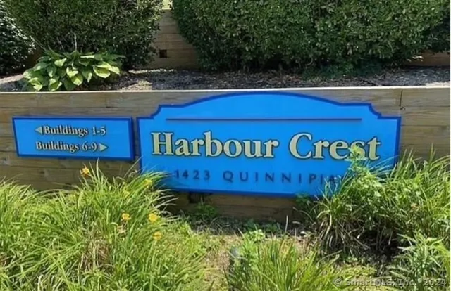 a sign that is sitting on a wooden bench