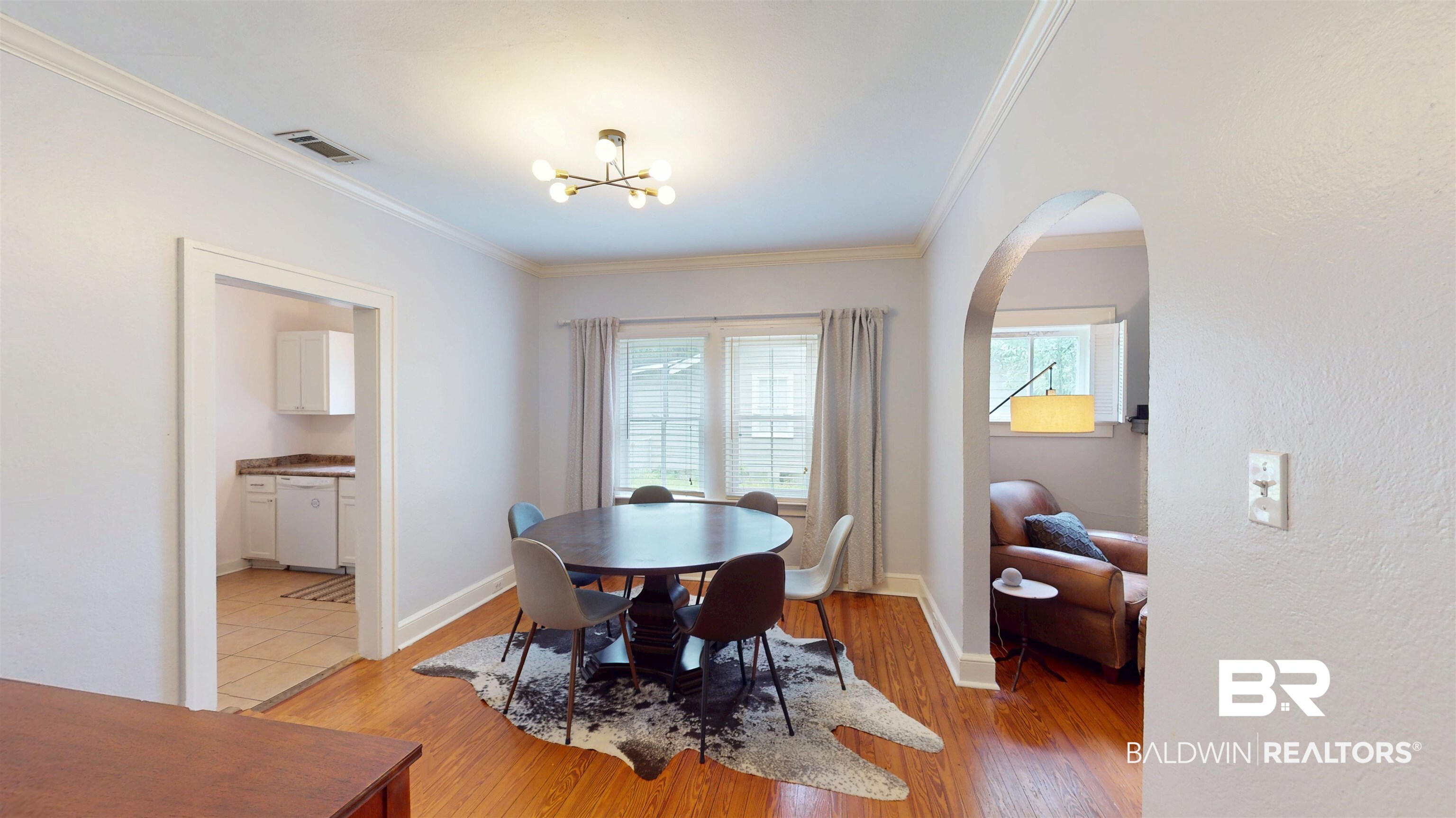 266 Westwood Street Mobile, AL 36606 - Photo 12 of 34 Dining room featuring arched walkways, crown molding, light wood-type flooring, a chandelier, and baseboards