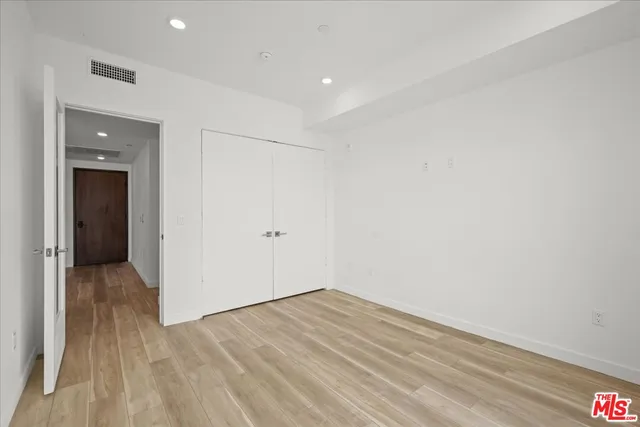 a view of hallway with wooden floor