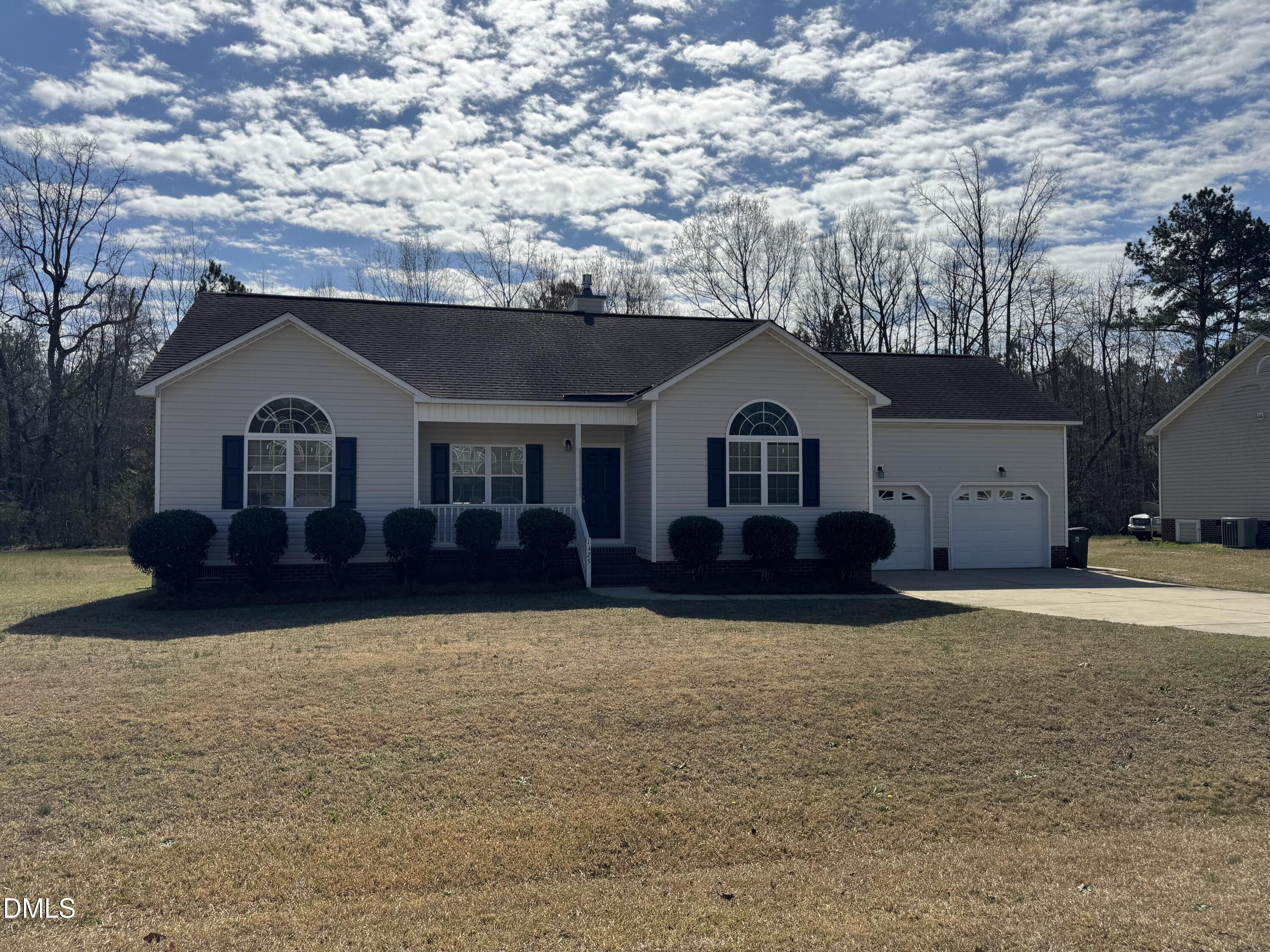 a front view of a house with yard and garage
