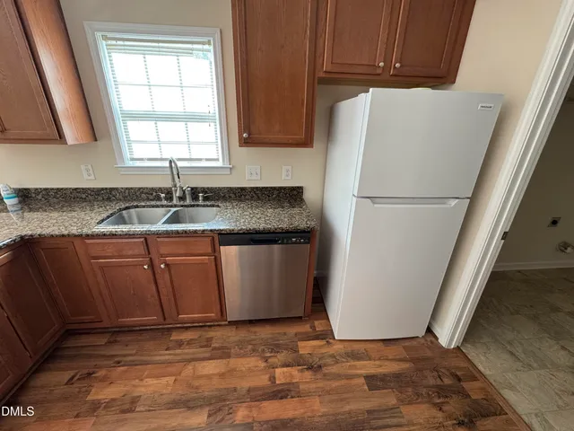 a white refrigerator freezer sitting inside of a kitchen