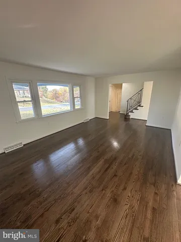 a view of an empty room and wooden floor
