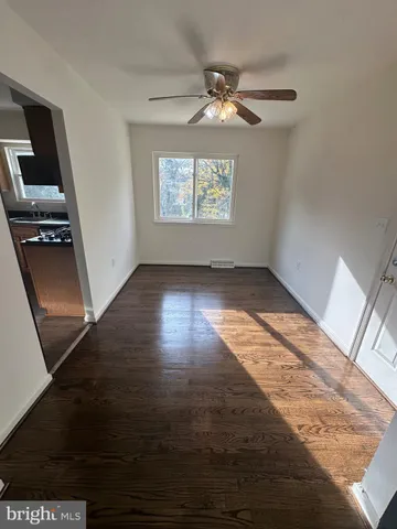 a kitchen with stainless steel appliances granite countertop a refrigerator a sink dishwasher a stove and white countertops with wooden floor