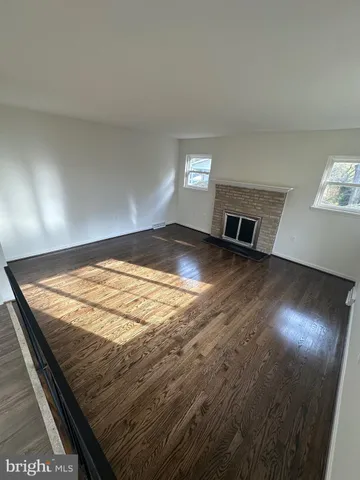 a view of a room with wooden floor and chair