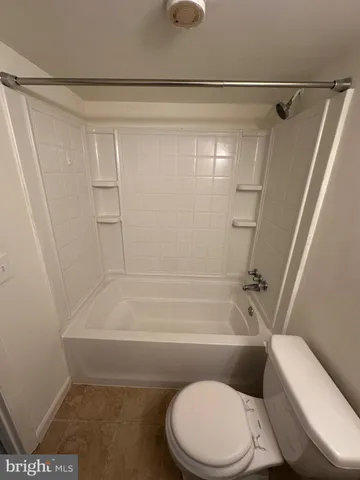 a view of a livingroom with an empty space and a window