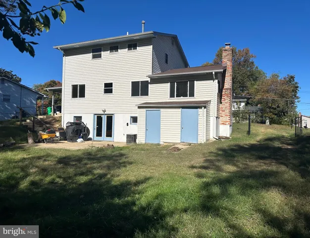 a view of a white house with a yard