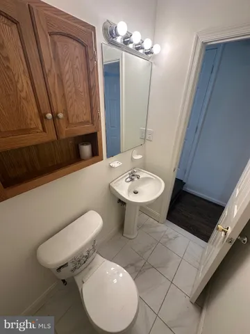 a bathroom with a sink a toilet and mirror