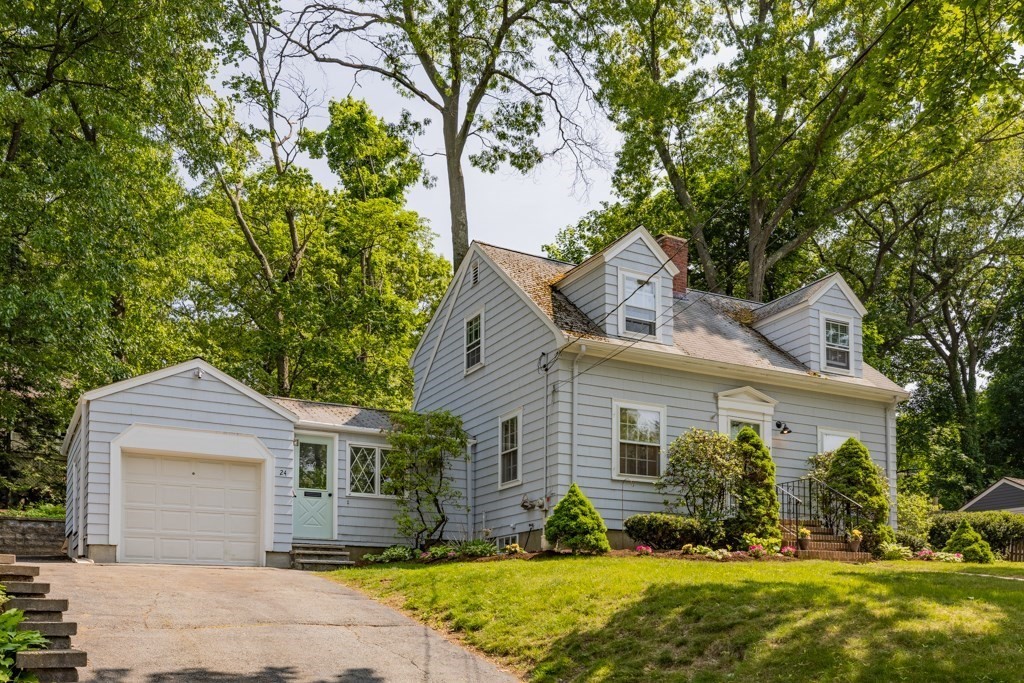 a front view of a house with a yard and outdoor seating