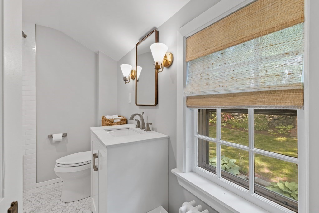 24 Pine Hill Circle Wakefield, MA 01880 - Photo 25 of 34 a bathroom with a toilet sink and mirror