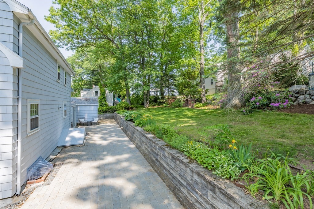 24 Pine Hill Circle Wakefield, MA 01880 - Photo 31 of 34 a backyard of a house with plants and large trees