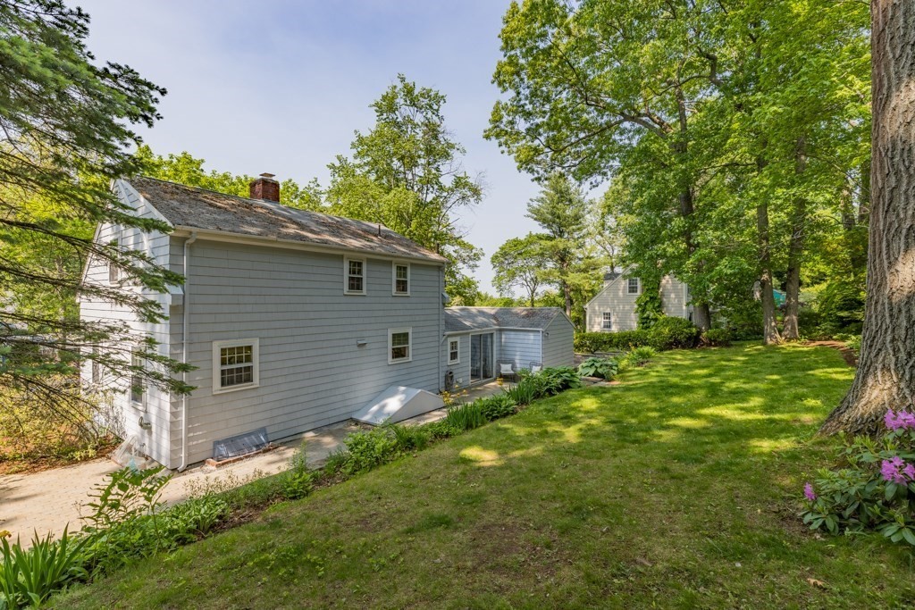 24 Pine Hill Circle Wakefield, MA 01880 - Photo 32 of 34 a backyard of a house with plants and large tree