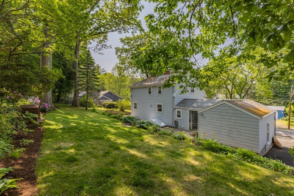 24 Pine Hill Circle Wakefield, MA 01880 - Photo 33 of 34 a backyard of a house with plants and large tree