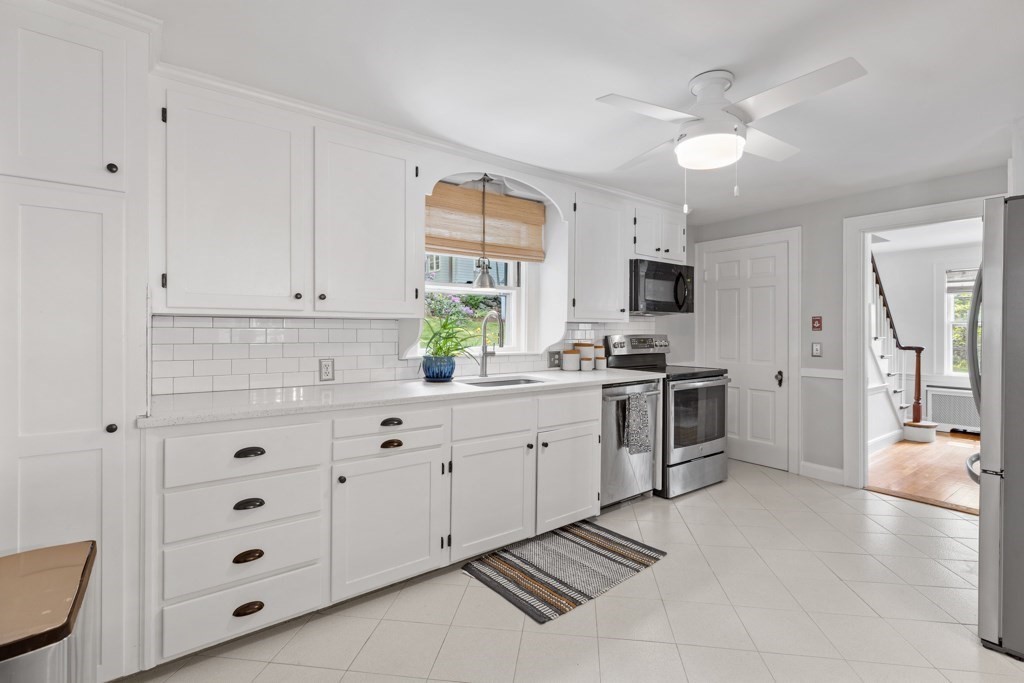 24 Pine Hill Circle Wakefield, MA 01880 - Photo 8 of 34 a kitchen with granite countertop a stove sink and cabinets