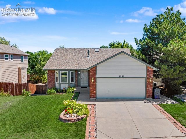 a view of a house with a backyard and a garden
