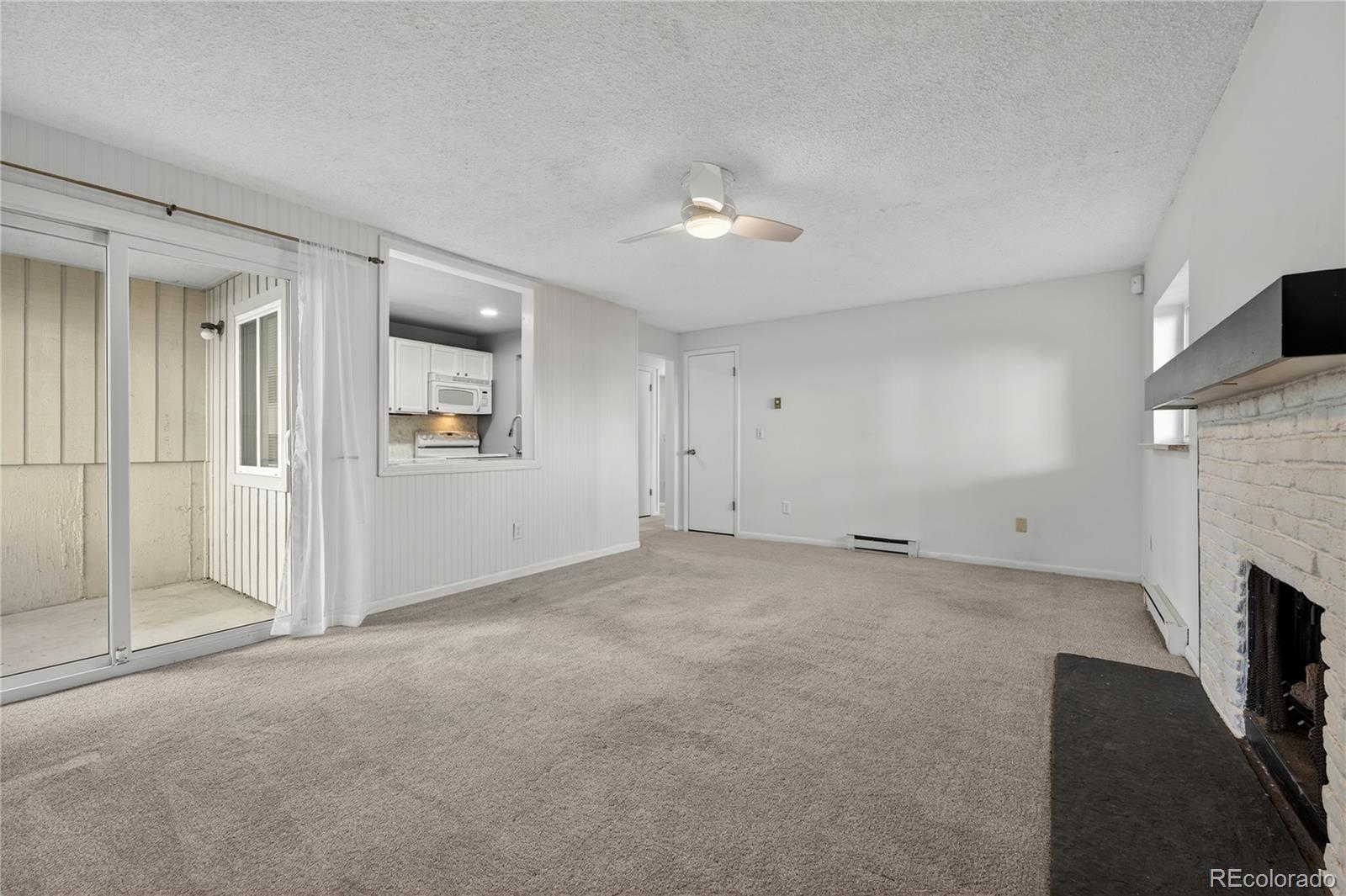 4066 South Atchison Way, Unit 101 Aurora, CO 80014 - Photo 12 of 36 an empty room with fireplace