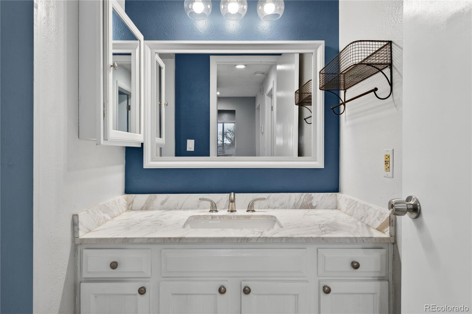 4066 South Atchison Way, Unit 101 Aurora, CO 80014 - Photo 17 of 36 a bathroom with a granite countertop sink mirror and double