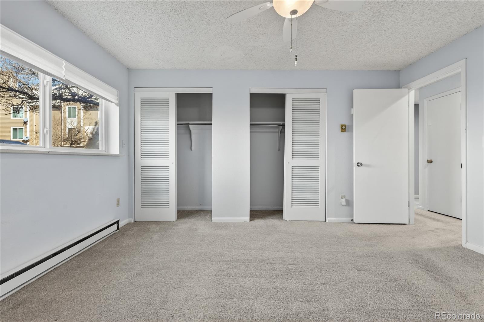 4066 South Atchison Way, Unit 101 Aurora, CO 80014 - Photo 20 of 36 an empty room with windows and closet
