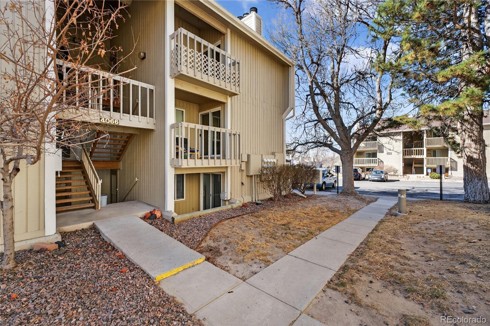 4066 South Atchison Way, Unit 101 Aurora, CO 80014 - Photo 2 of 36 a view of multiple houses with a pathway