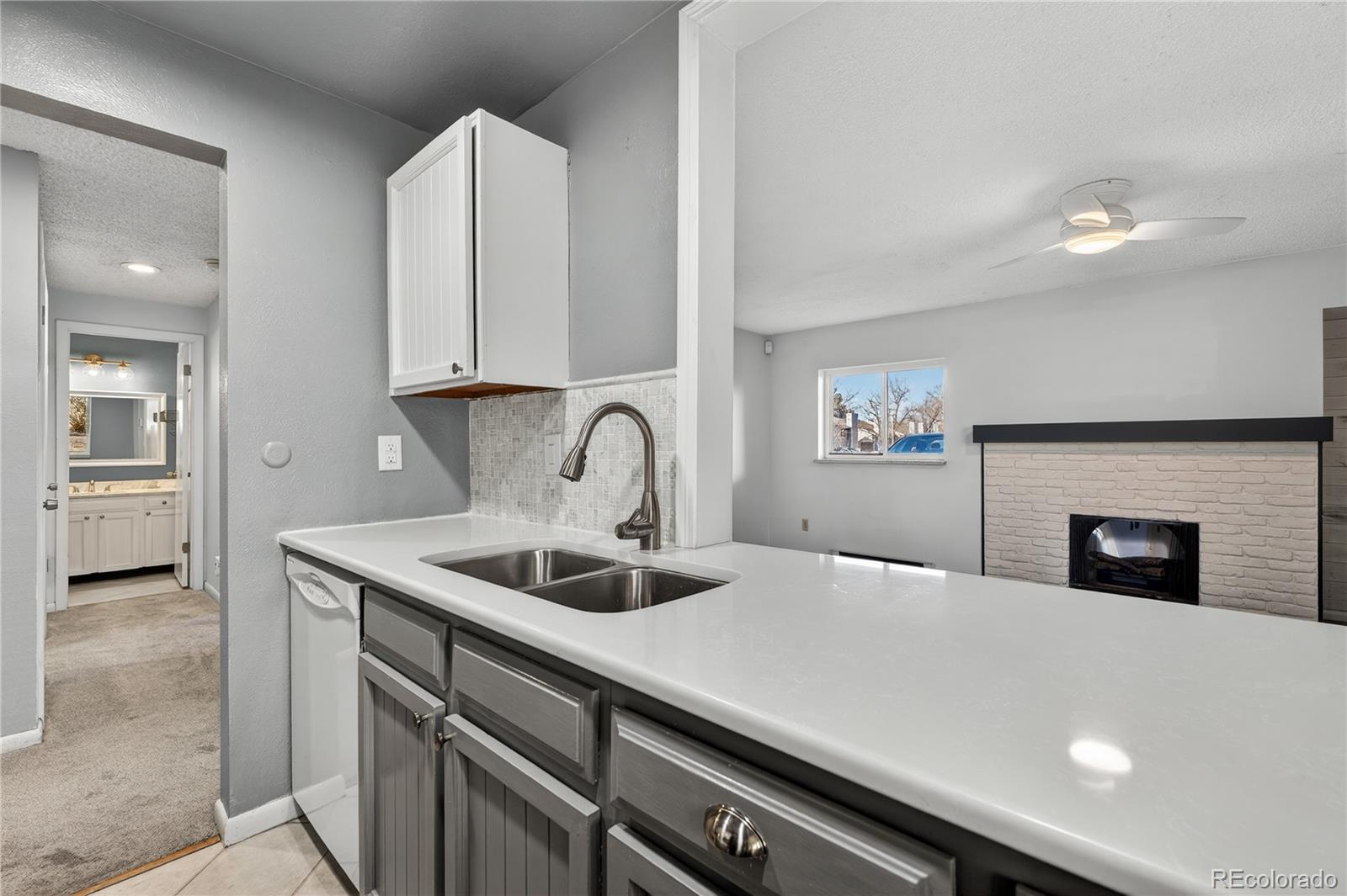 4066 South Atchison Way, Unit 101 Aurora, CO 80014 - Photo 8 of 36 a kitchen with a sink and a stove top oven