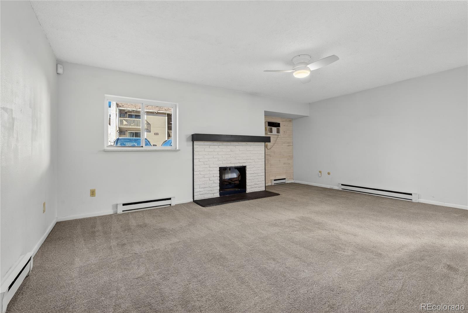 4066 South Atchison Way, Unit 101 Aurora, CO 80014 - Photo 10 of 36 a view of an empty room with a fireplace