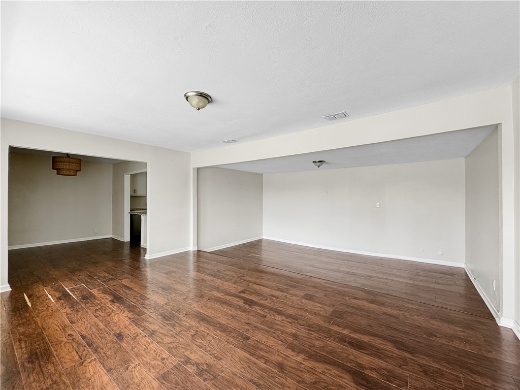 1034 Mc Clendon Street Corpus Christi, TX 78404 - Photo 3 of 19 a view of an empty room with wooden floor and a window