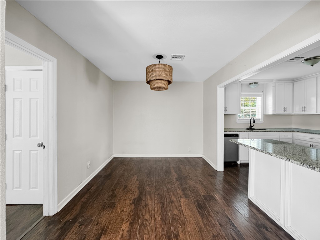 1034 Mc Clendon Street Corpus Christi, TX 78404 - Photo 6 of 19 a kitchen with a hard wood floor white cabinets and wooden floor