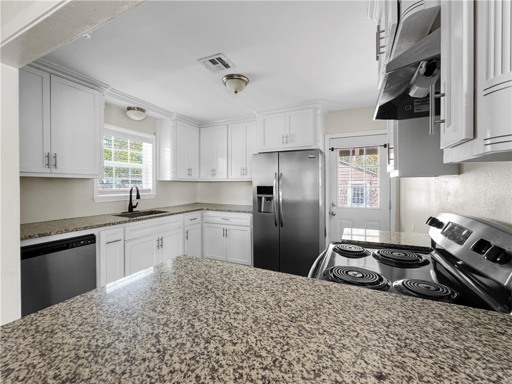 1034 Mc Clendon Street Corpus Christi, TX 78404 - Photo 8 of 19 a kitchen with stainless steel appliances granite countertop a sink stove and refrigerator
