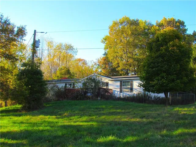 a house view with swimming pool and garden