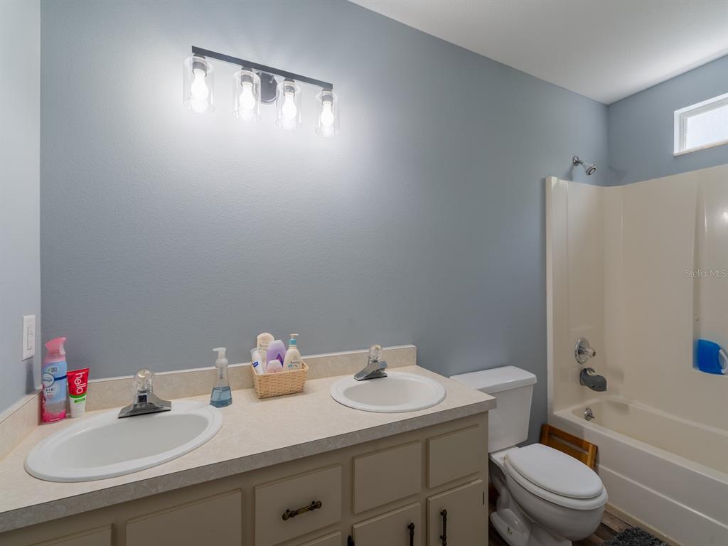 4381 Northeast 105th Place Anthony, FL 32617 - Photo 32 of 49 a bathroom with a sink toilet and shower