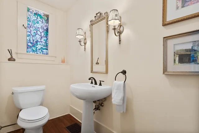 a bathroom with a toilet sink and mirror