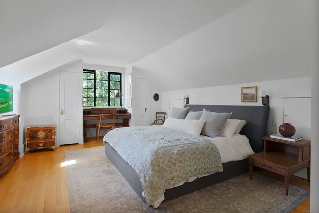 a bedroom with a bed and a couch