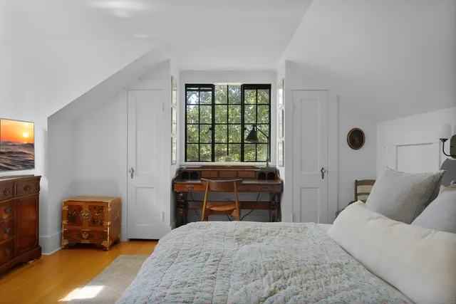 a bedroom with a bed and a tv